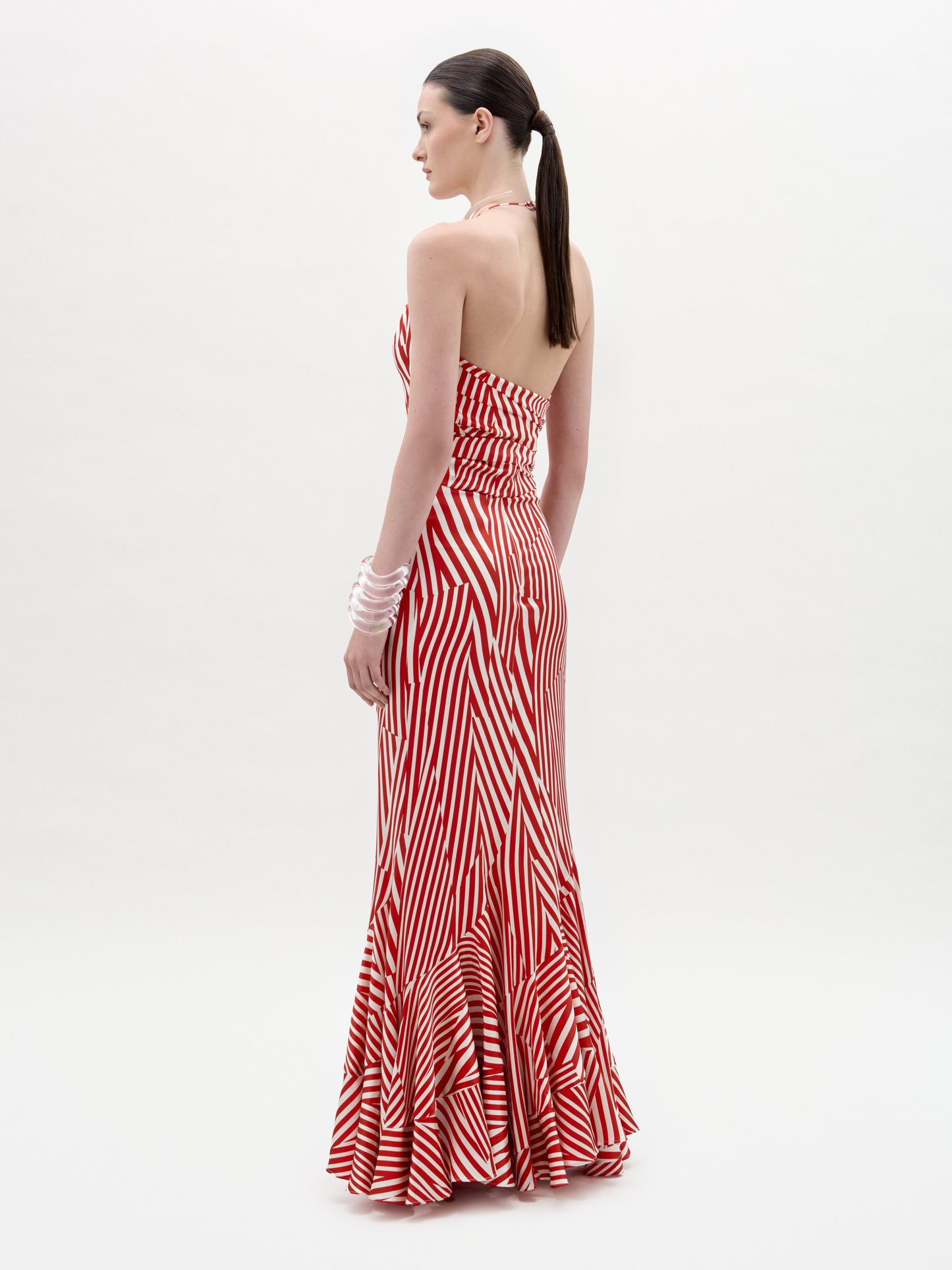 Woman wearing a red and white striped dress on a white background