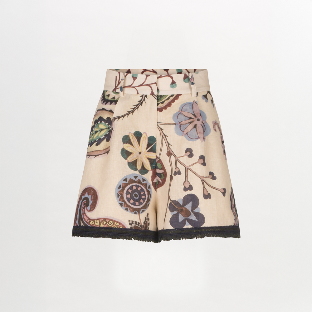 The Arnit Short by Silvia Tcherassi US is a beige linen, high-waisted style with a multicolored floral and paisley print, geometric embroidery, a wide waistband, and black fringe trim at the hem.
