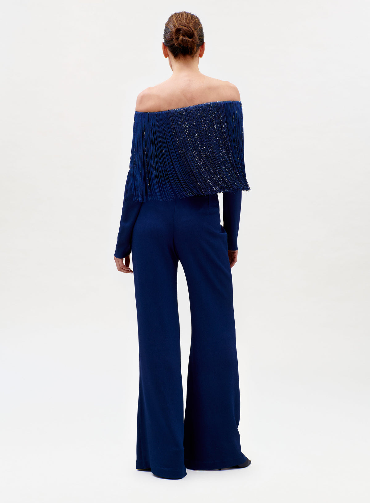 Navy blue off-shoulder jumpsuit worn by a model on a white background