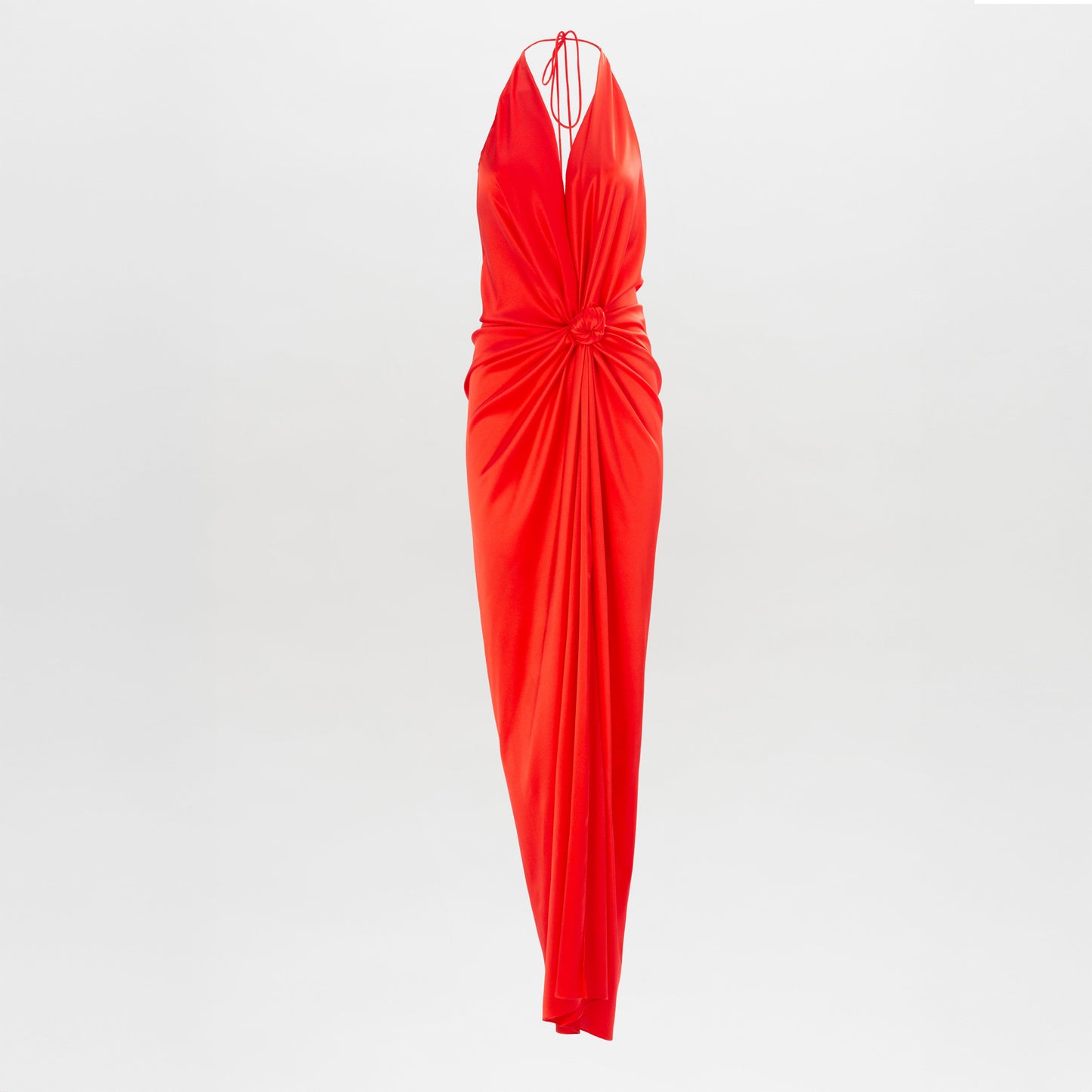 The Jazmin Dress by SVT DESIGNS is a sleeveless, floor-length red halter gown featuring a deep V-neckline, gathered waist, and center knot detail, shown against a plain white background.