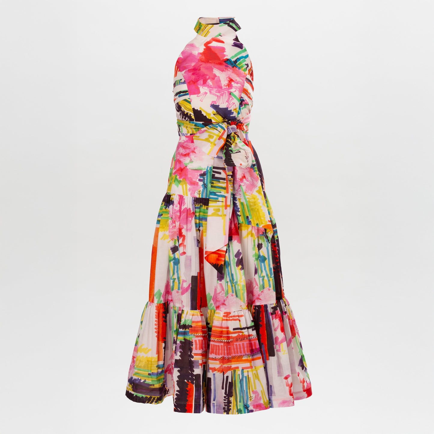 The Dilara Dress Set by SVT DESIGNS is a sleeveless, floor-length dress with a high neckline, belted waist, and an abstract floral print in pink, yellow, orange, green, and black on a white background.