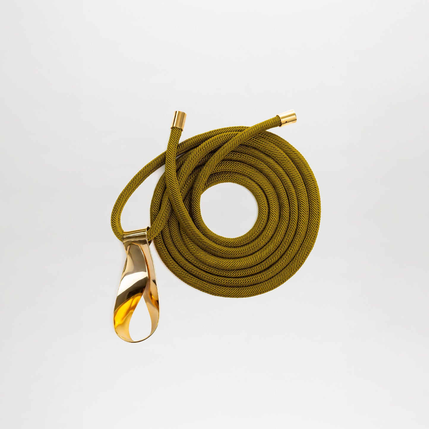 The Daiana Belt by SVT DESIGNS, crafted from Italian olive green cord with gold metal ends and a polished gold-toned teardrop pendant, is shown on a plain white background.
