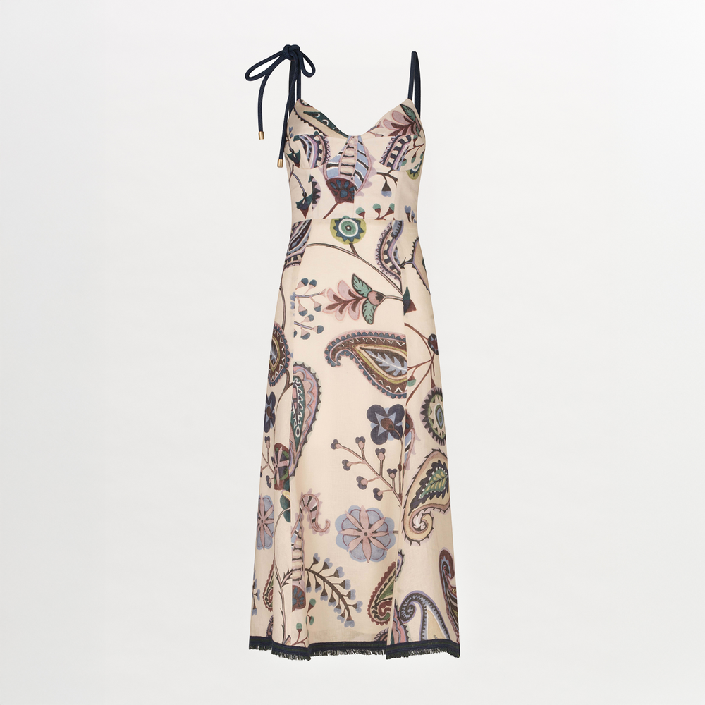 The Dalil Dress by Silvia Tcherassi US is a sleeveless, cream midi dress with a fitted bodice, black trim, single shoulder tie, and abstract paisley print with multicolored floral accents.