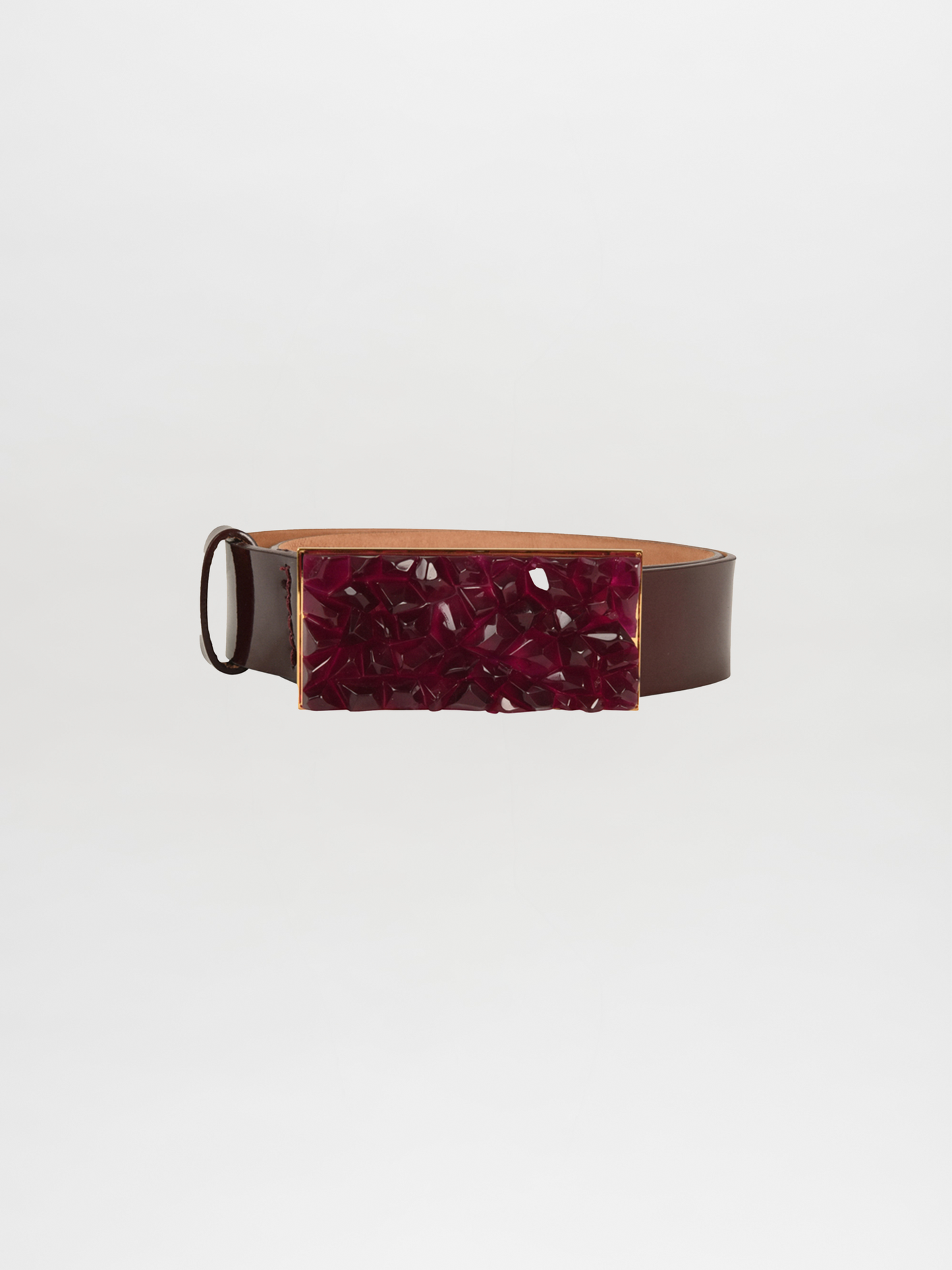 The Dora Belt Brown Burgundy by SilviaTcherassi is a dark brown leather belt featuring a wide rectangular modern resin buckle with a textured dark red surface and glossy finish, set against a plain white background for a sophisticated touch.