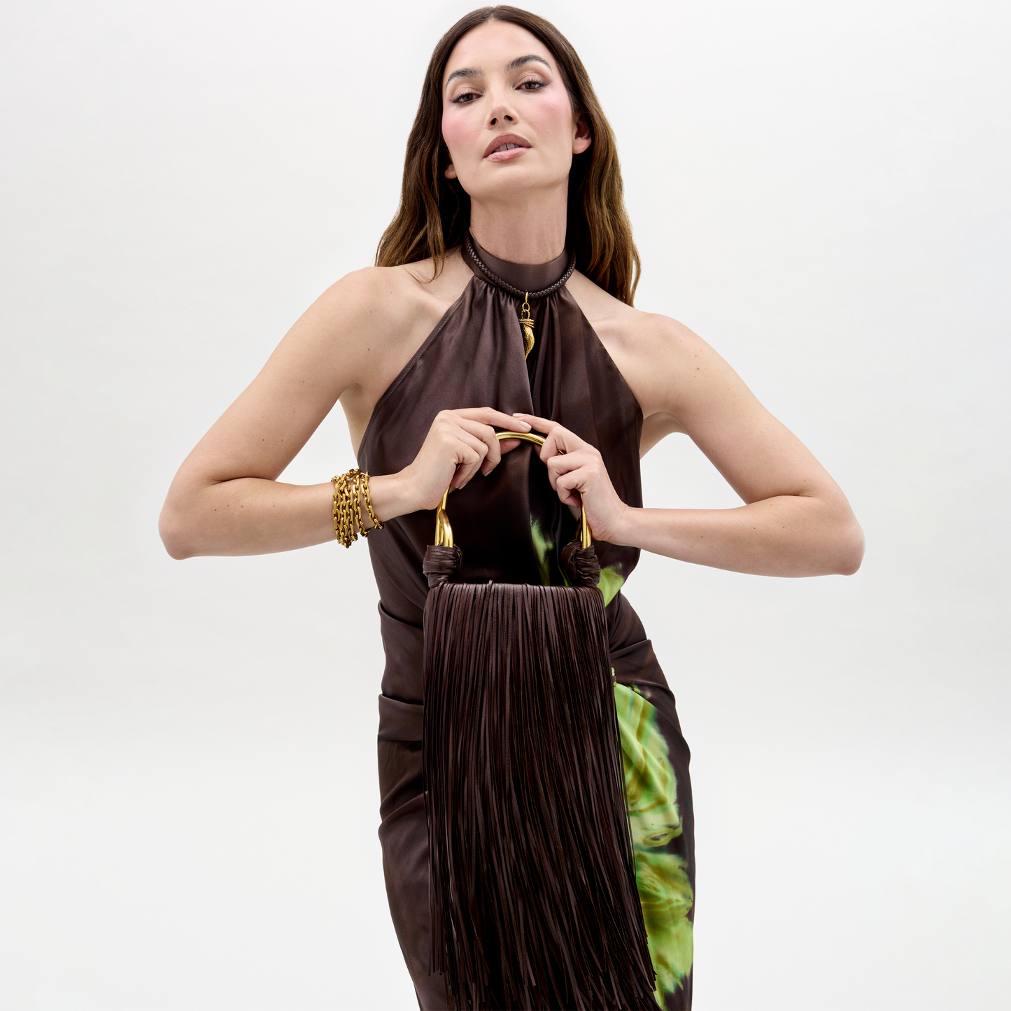 Woman wearing a brown halter neck dress with a white background