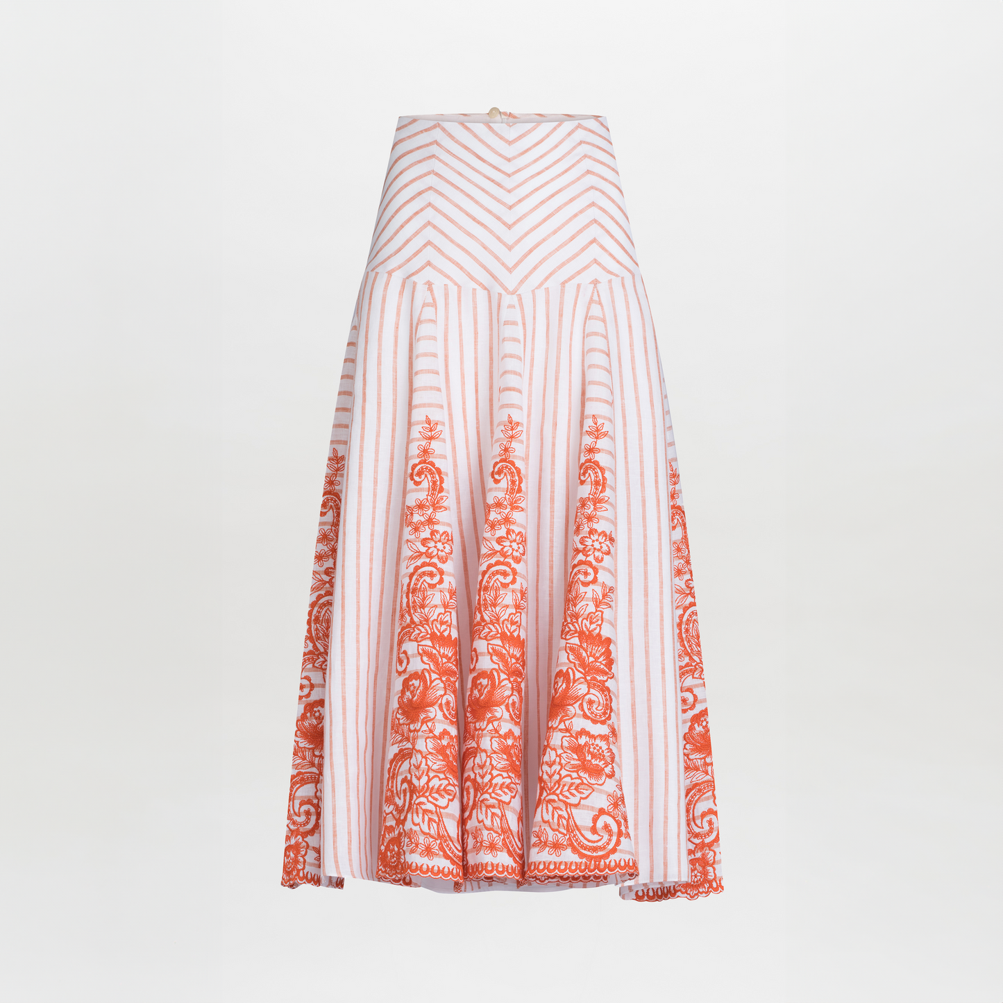 The Fairus Skirt by SVT DESIGNS is a high-waisted A-line midi skirt with vertical pink stripes and orange embroidered linen floral details near the hem, shown on a plain white background.