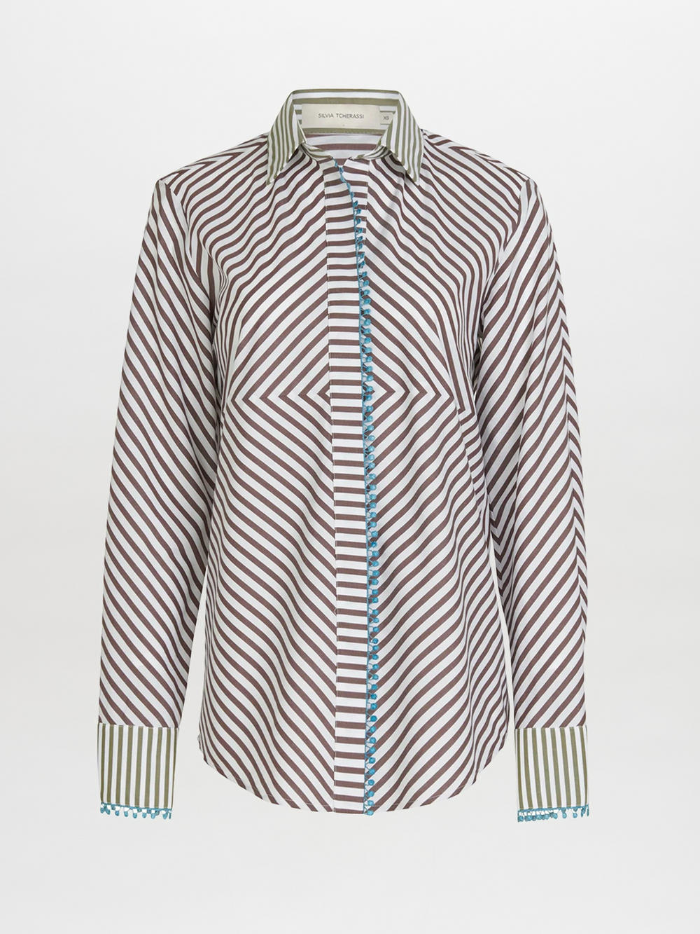 The Silvia Tcherassi Melissa Blouse Brown Stripes features brown and white diagonal stripes, a green and white striped collar and cuffs, and blue trim along the button placket, shown on a plain white background.