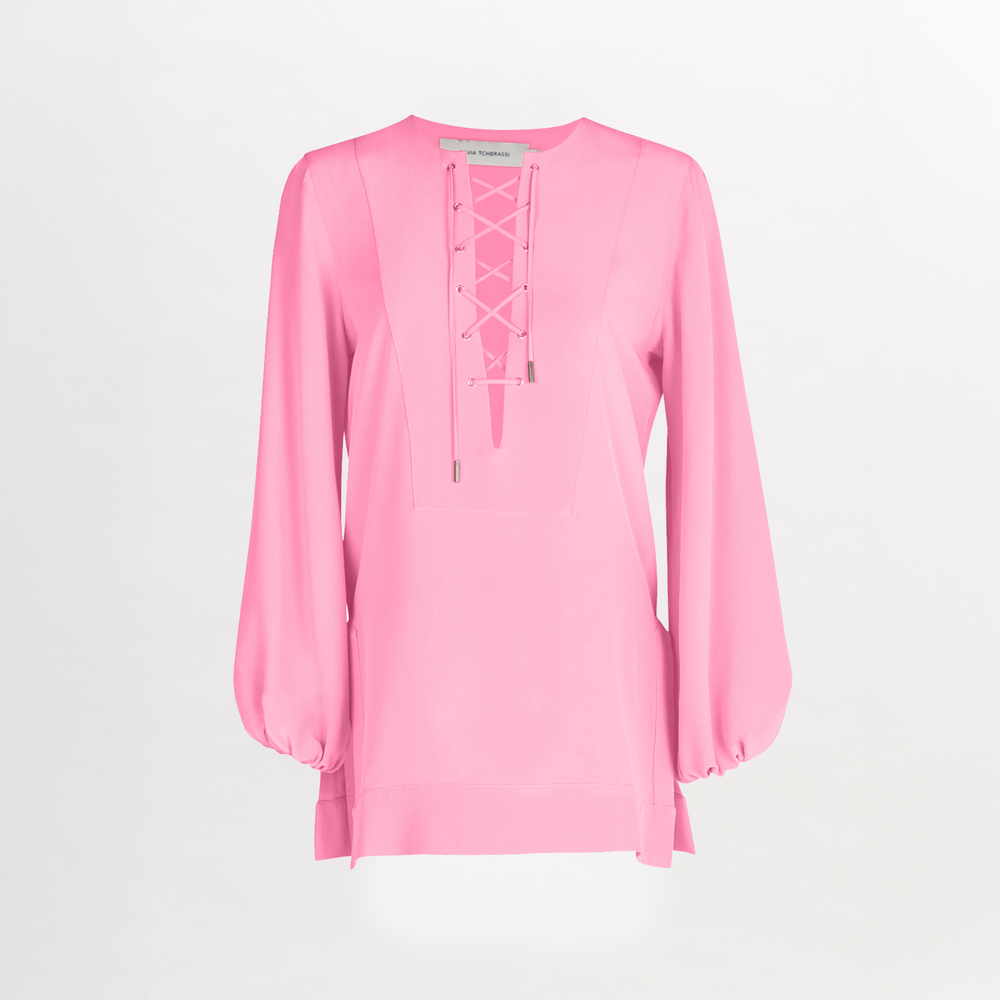 The Silvia Tcherassi Merve Blouse features long sleeves, a bright pink silk-like fabric, a V-neck lace-up front, gathered cuffs, and a loose fit for effortless casual glamour with clean lines.