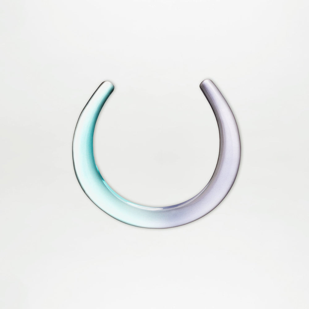 The Oba Chocker by SVT DESIGNS is a sculptural, U-shaped piece made from Italian PMMA, featuring a smooth gradient from light teal to pale violet, displayed on a plain white background.