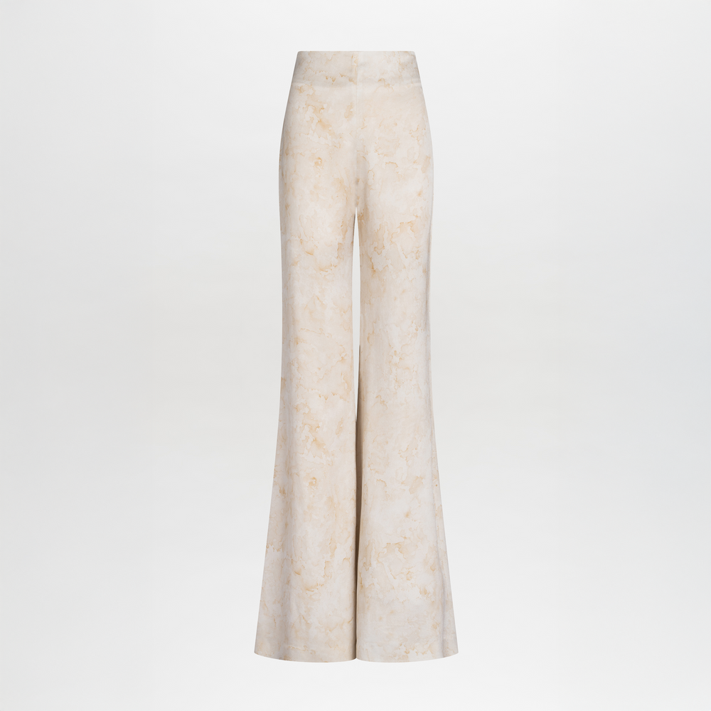 The Palermo Pant by SVT DESIGNS features a high-waisted, wide-leg silhouette in a light beige abstract print, displayed on a plain white background. The pants have a fitted waist and flared legs.