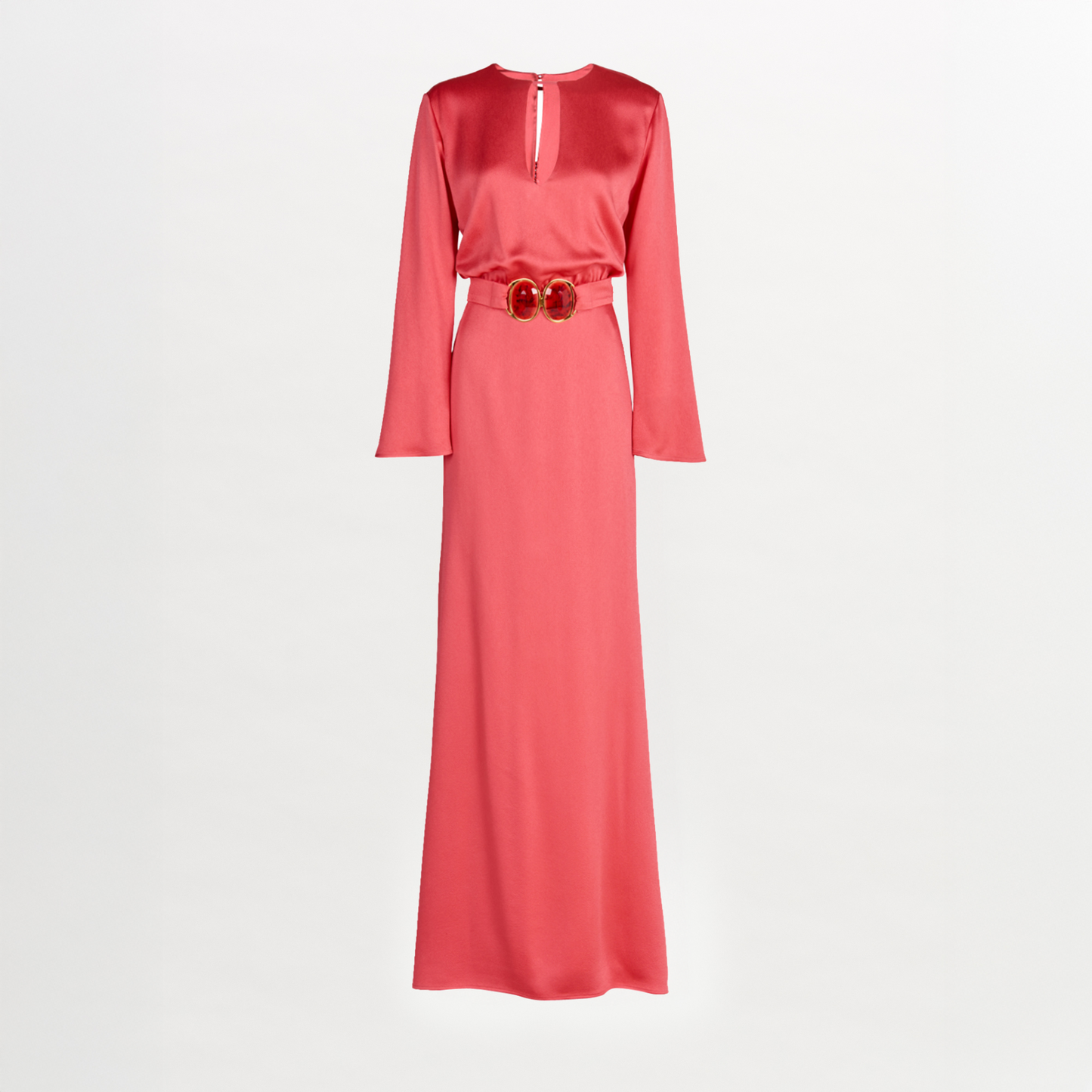 The Ravenna Dress by Silvia Tcherassi is a long-sleeved, floor-length pink hammered satin column dress with a keyhole neckline and a matching belt with a double-circle buckle at the waist.