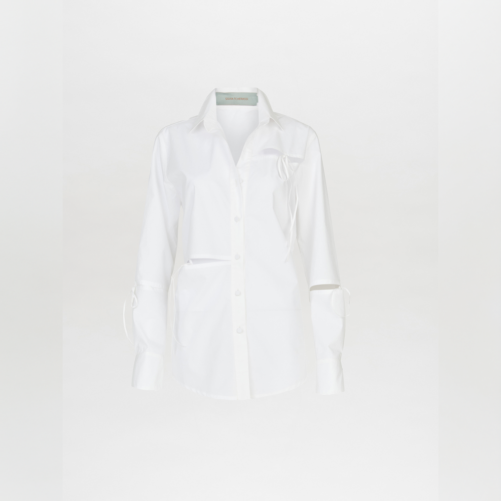 The Silvia Tcherassi Simona Blouse White features tailored sleeves, a collar, front chest pocket, and unique cut-out sleeve details. Shown against a plain white background.