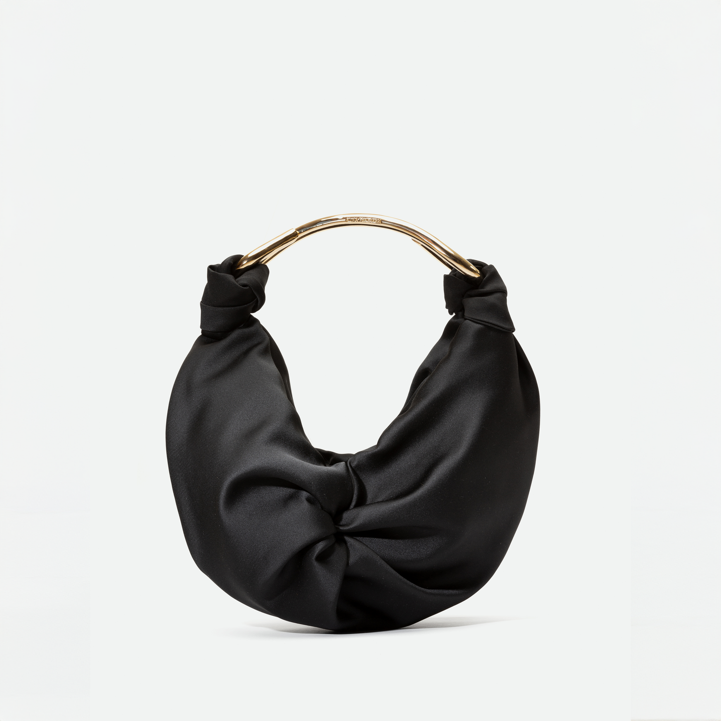 The Sofia Bag Small by SVT DESIGNS is a black handbag in soft Italian fabric, featuring a gathered design and a curved gold-toned handle, shown against a plain white background.
