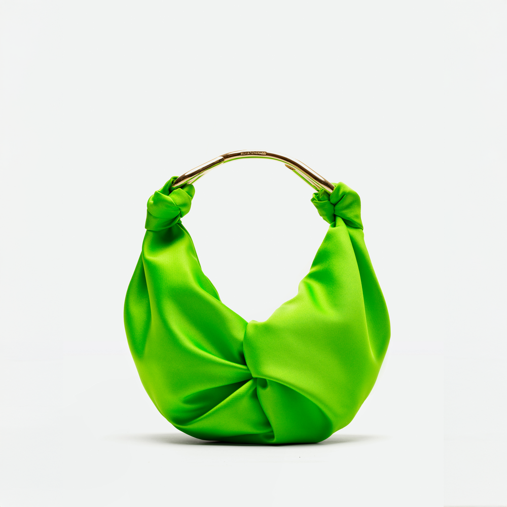 The Sofia Bag Small by SVT DESIGNS is a bright green handbag in luxurious doppio raso with a twisted, knotted design and a short, curved gold-tone handle, shown on a plain white background.