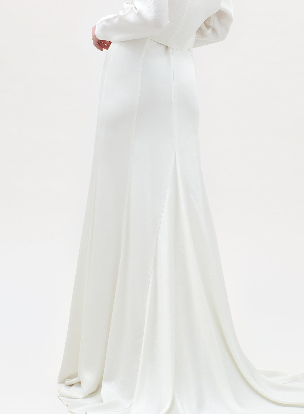 White wedding dress with a long train on a white background
