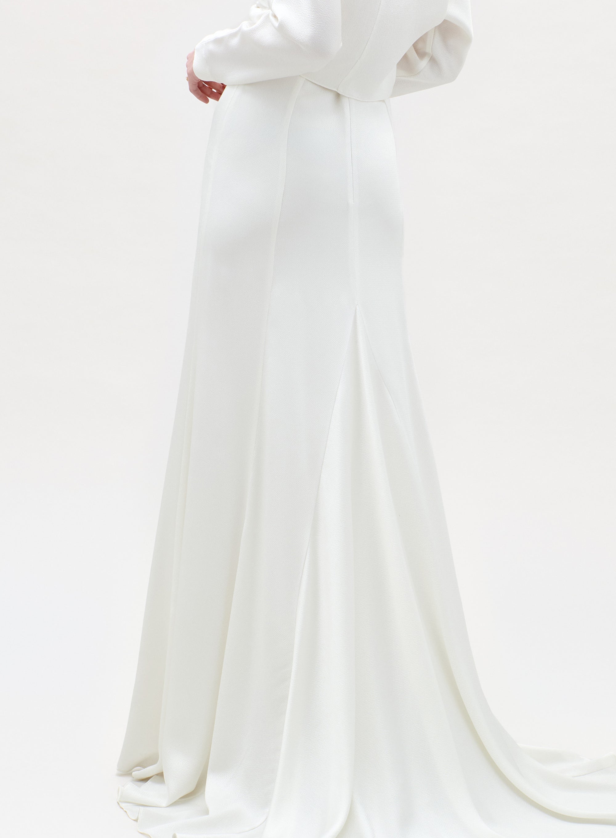White wedding dress with a long train on a white background
