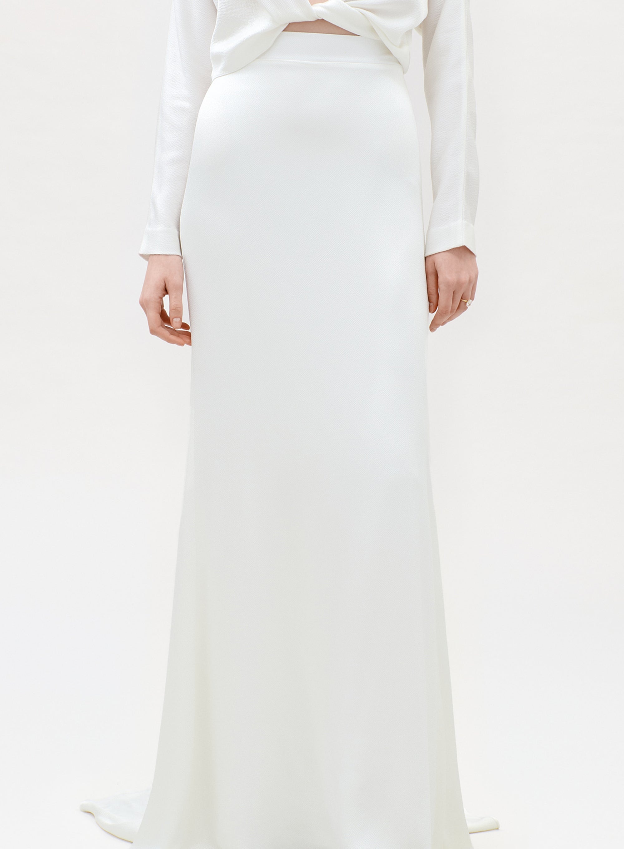 White outfit with a long skirt on a white background