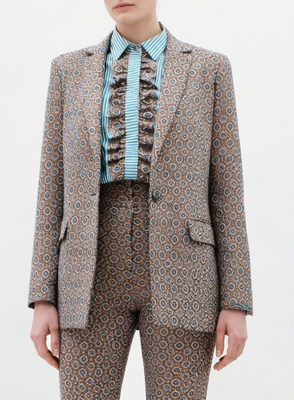Person wearing a patterned suit with a white background