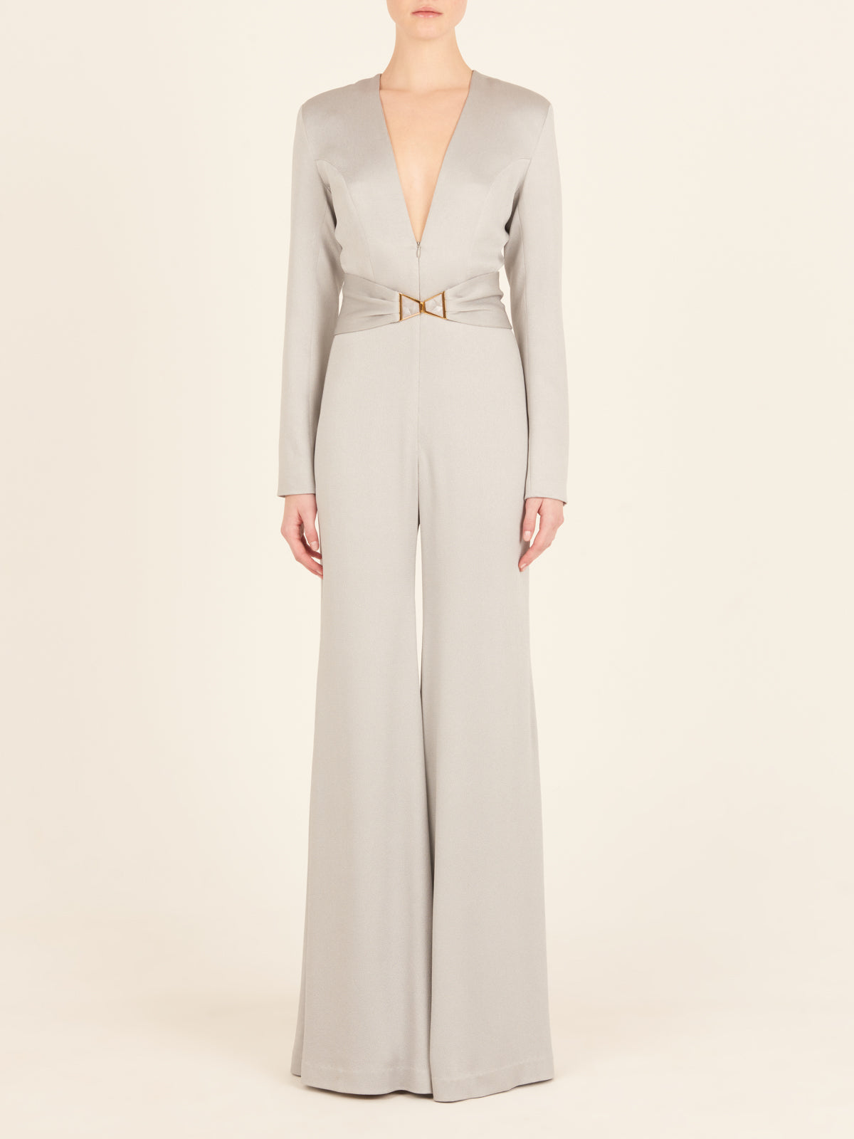 A Taboa Jumpsuit Gray with a waist-defining belt.