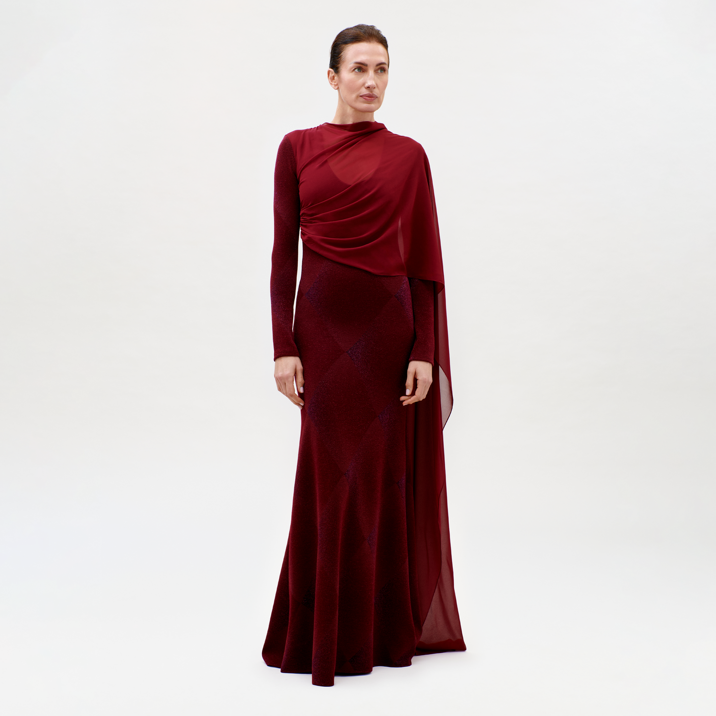 Woman wearing a burgundy evening gown on a white background