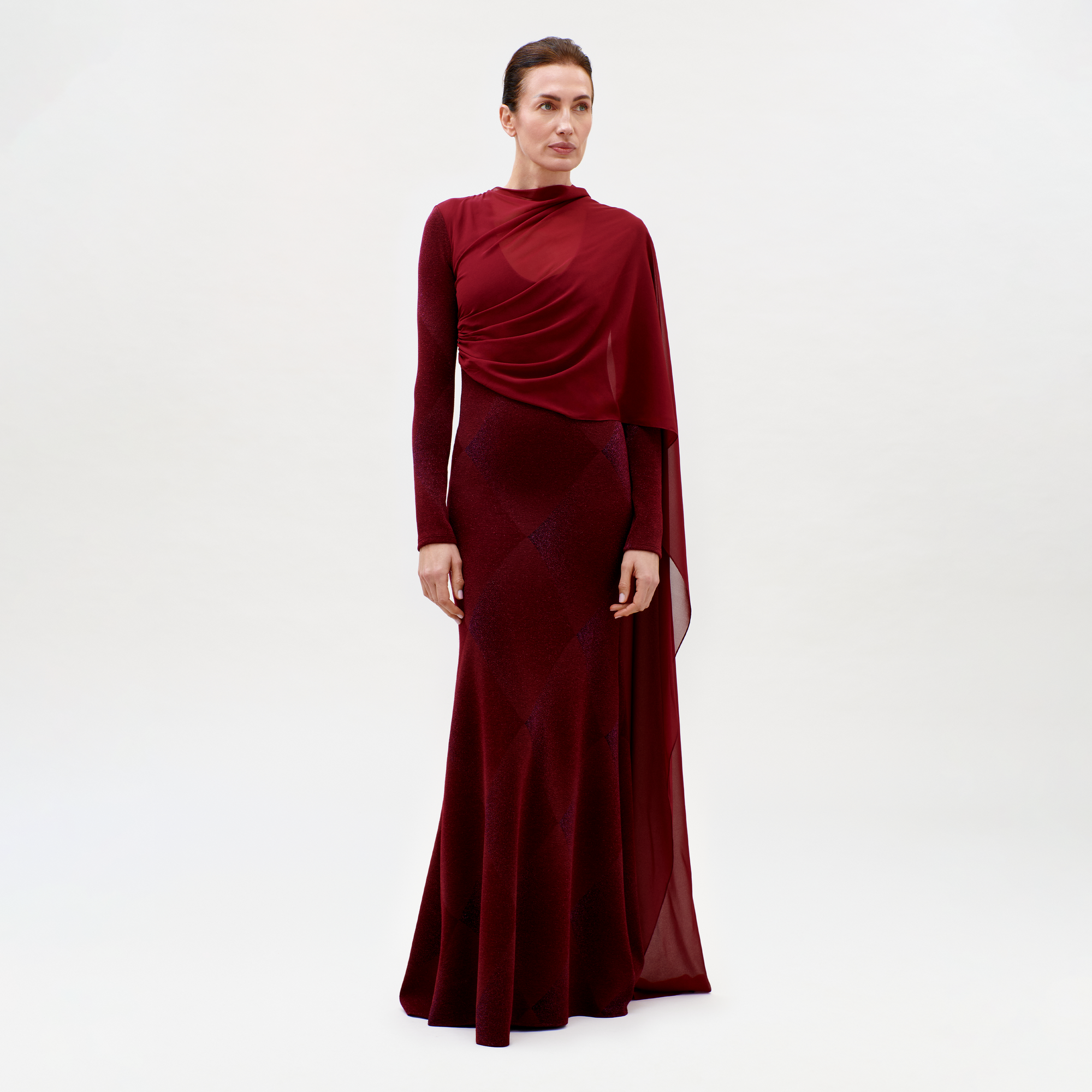 Woman wearing a burgundy evening gown on a white background