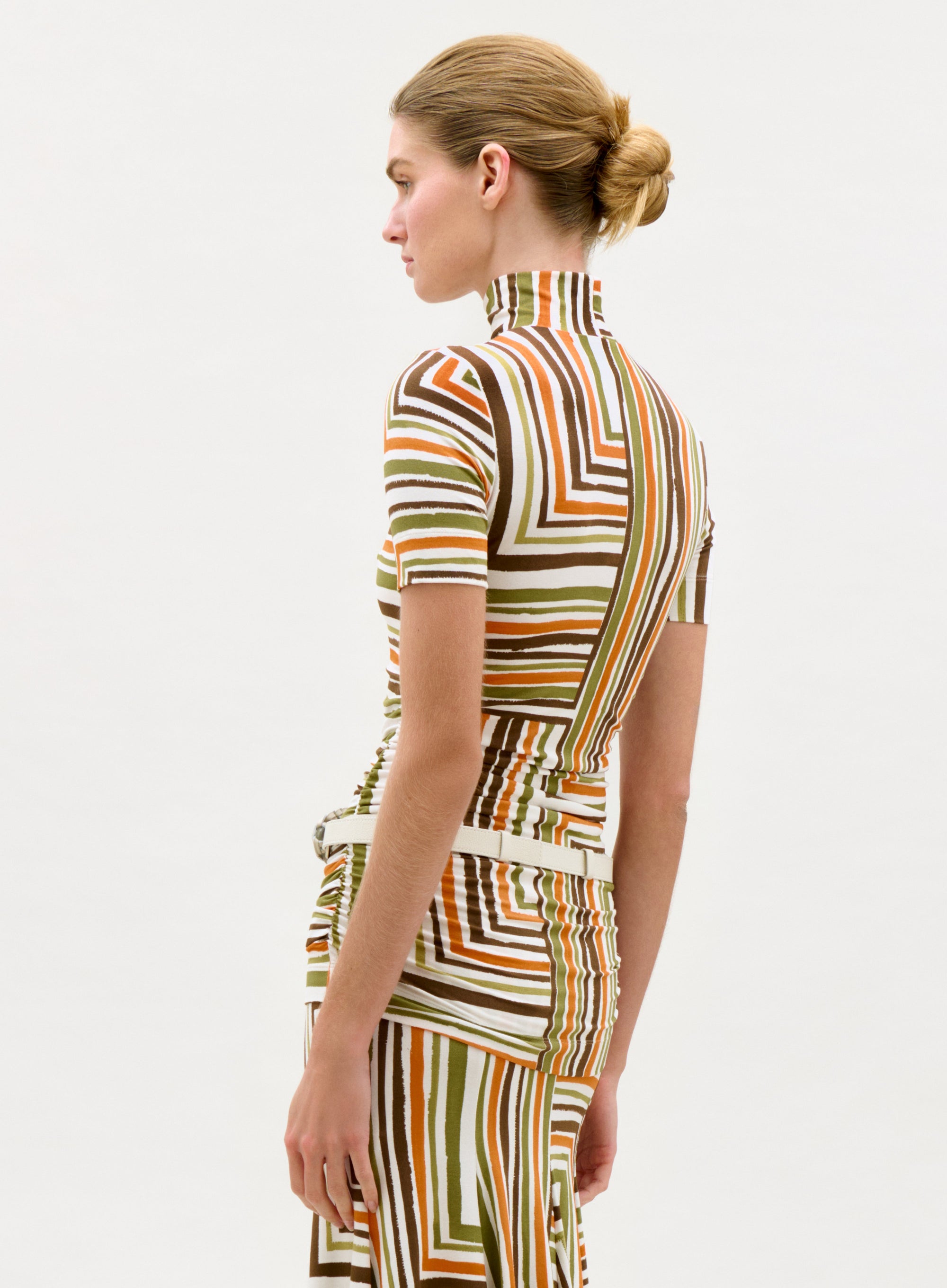 Woman wearing a patterned dress on a white background
