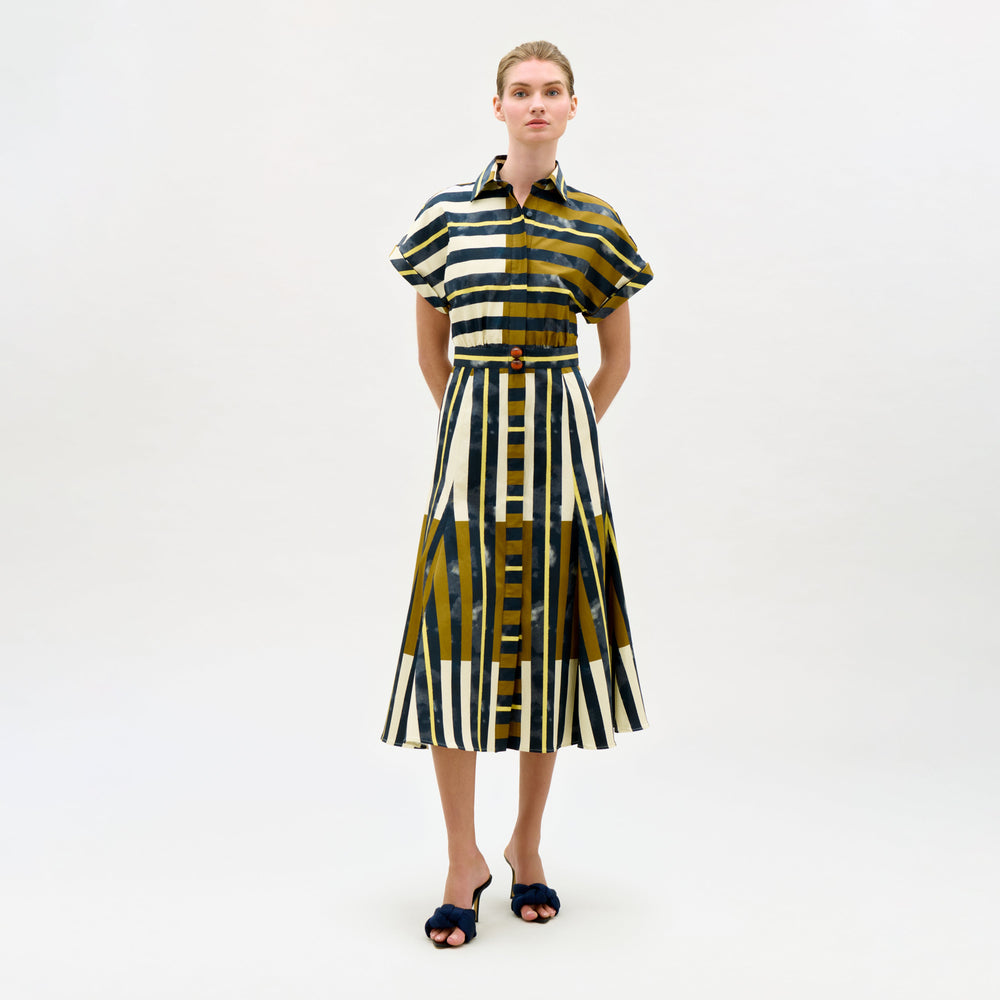 Woman wearing a patterned dress on a white background