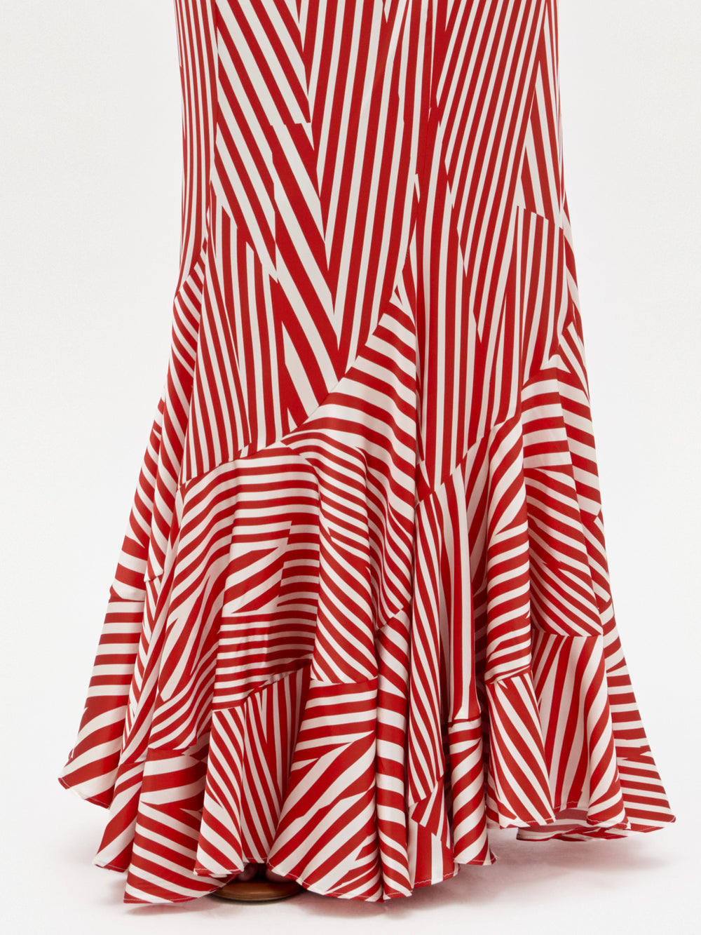 A close-up of the lower half of the Florina Skirt by SVT DESIGNS, featuring bold red and white diagonal and vertical stripes with a ruffled hem, crafted from Italian fabric. The background is plain white.