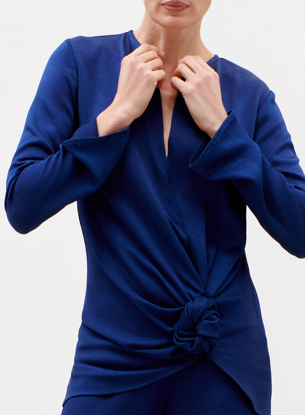 Blue dress with a knot detail on a white background