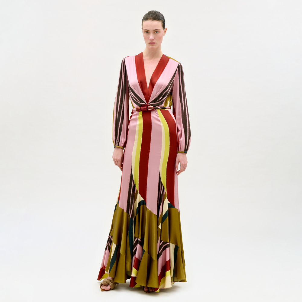 Woman wearing a long, patterned dress on a white background