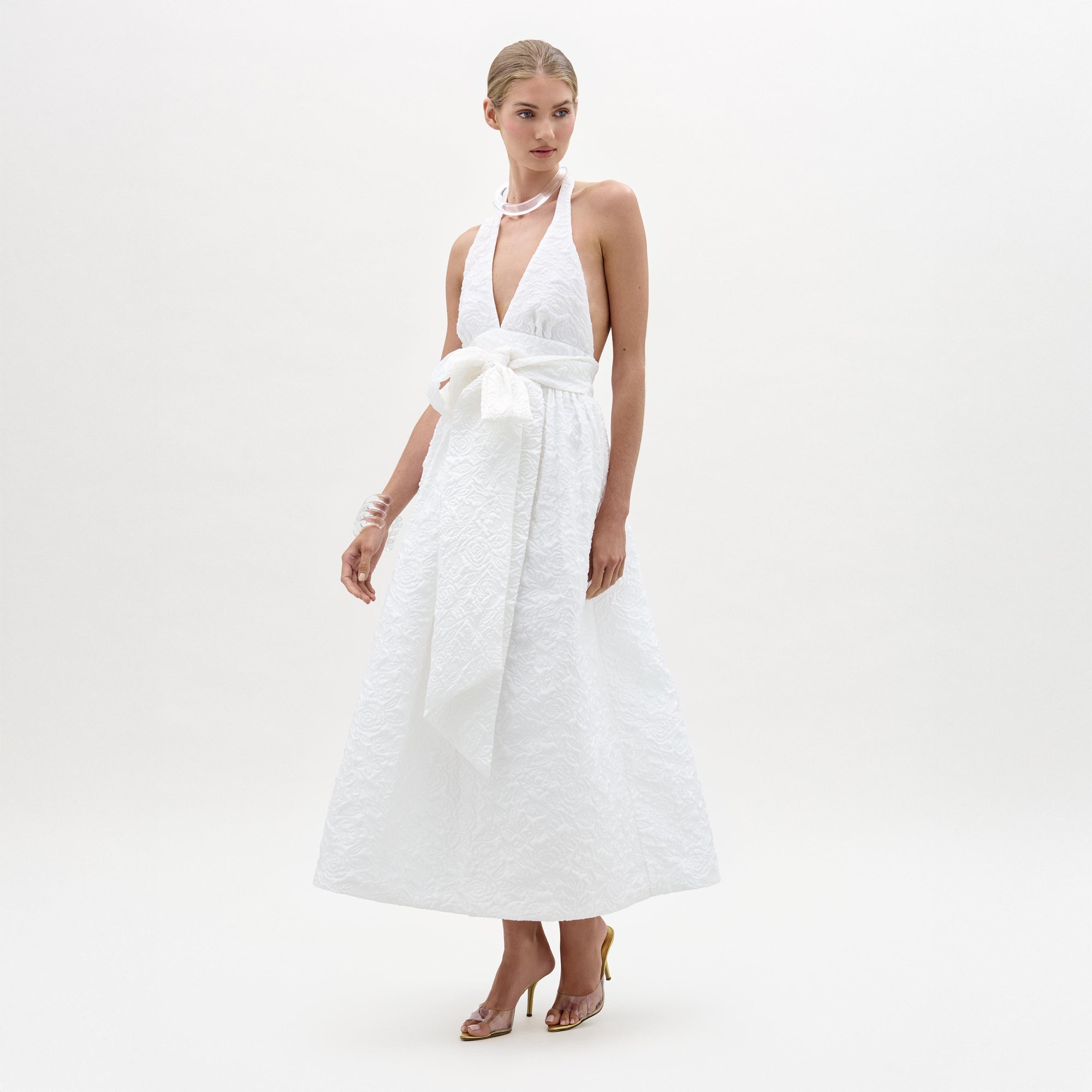 Woman wearing a white dress on a white background