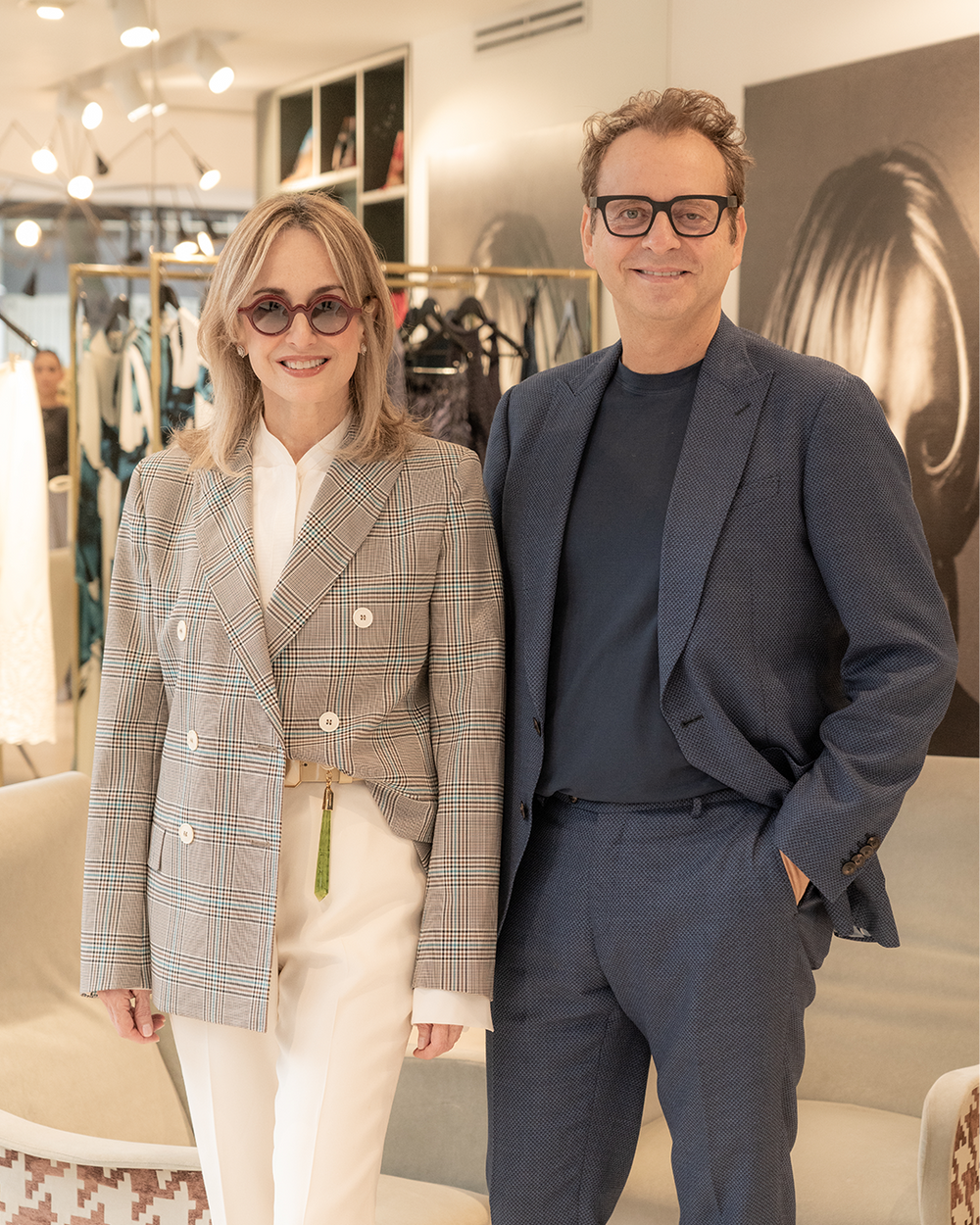 A-woman-in-a-plaid-blazer-stands-next-to-a-man