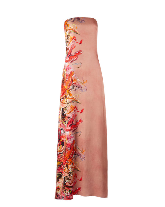 A woman stands in a long, strapless Adalgisa Dress Abstract Coral with red, orange, and yellow floral accents on the side against a plain white background. This stunning piece is available for pre-order now with an estimated ship-by date of February 1st, 2025.