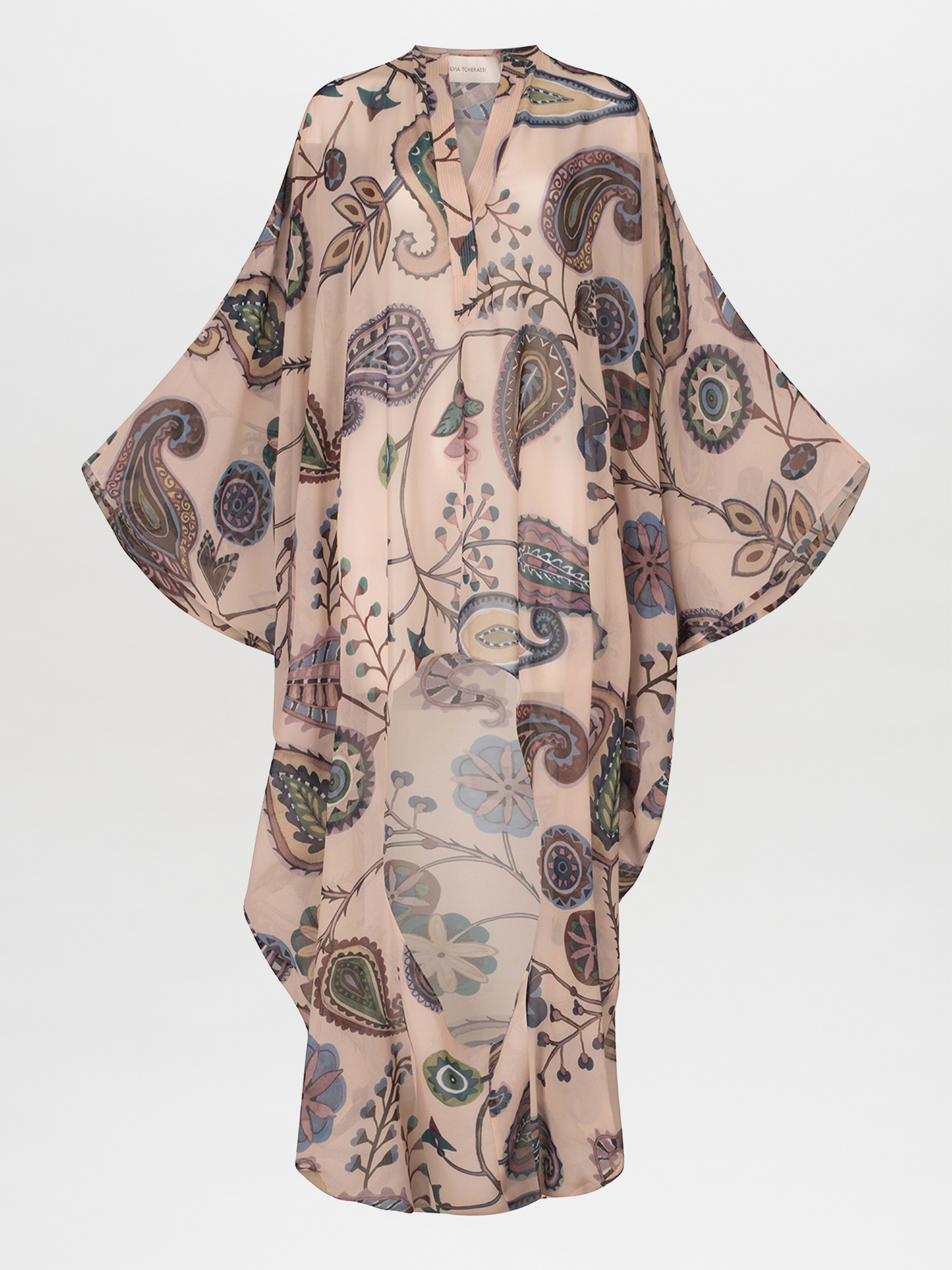 The Adaya Kaftan by Silvia Tcherassi US is a long-sleeved, flowing chiffon garment with sheer fabric featuring intricate abstract paisley and floral designs in muted tones. It has a loose fit and an airy look set against a plain white background.