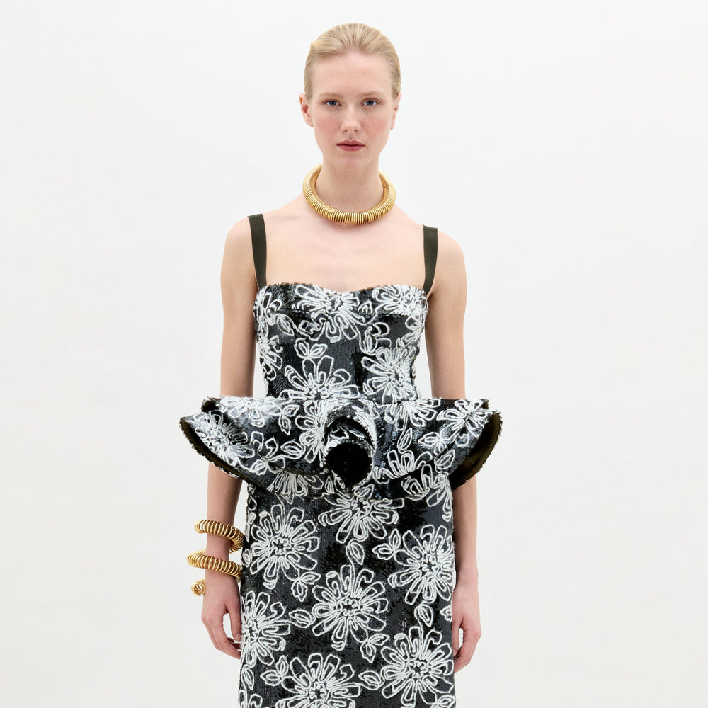 A woman wearing the Adriana Top black and white on a white background