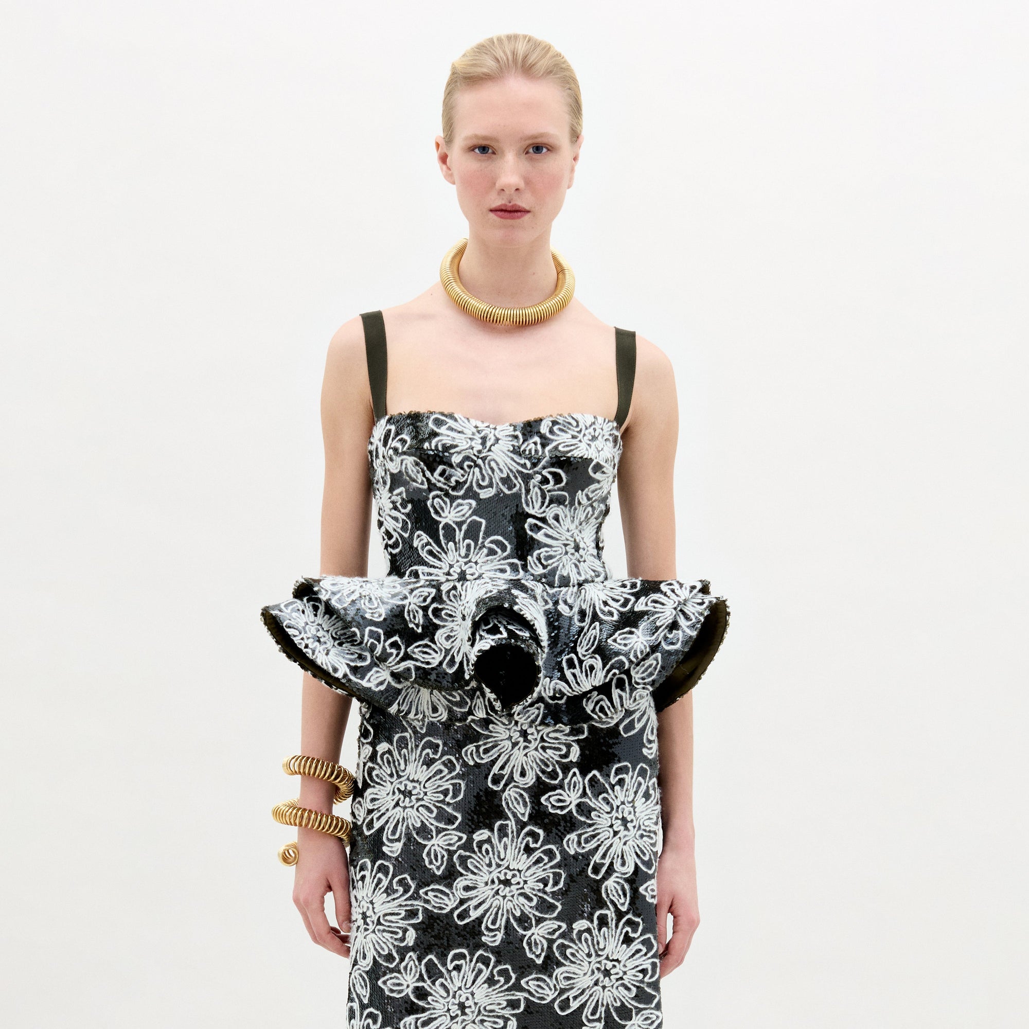 A woman wearing the Adriana Top black and white on a white background