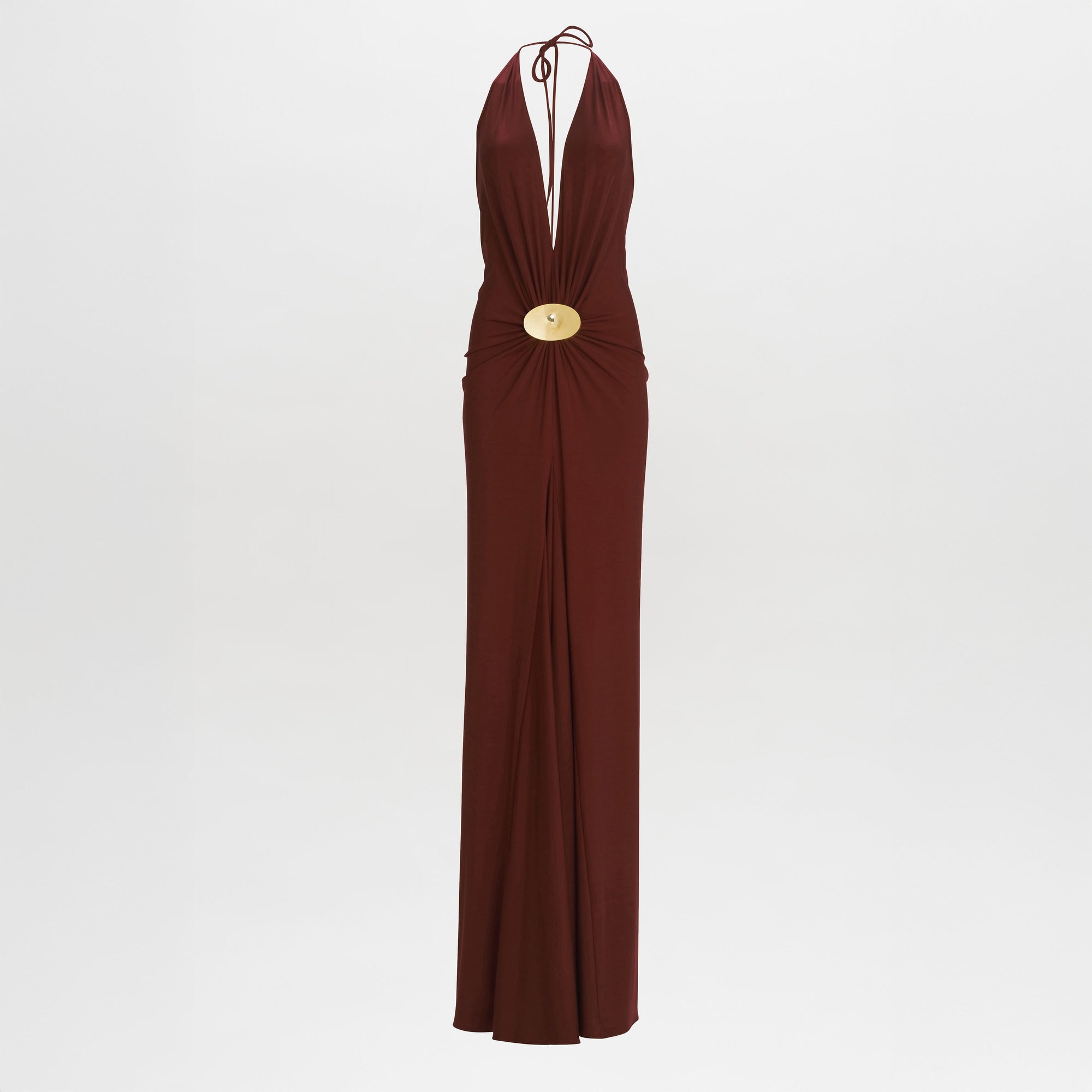 The Aiko Dress is a sleeveless, deep red halter-neck maxi with a plunging neckline, gold central embellishments, and a floor-length skirt.