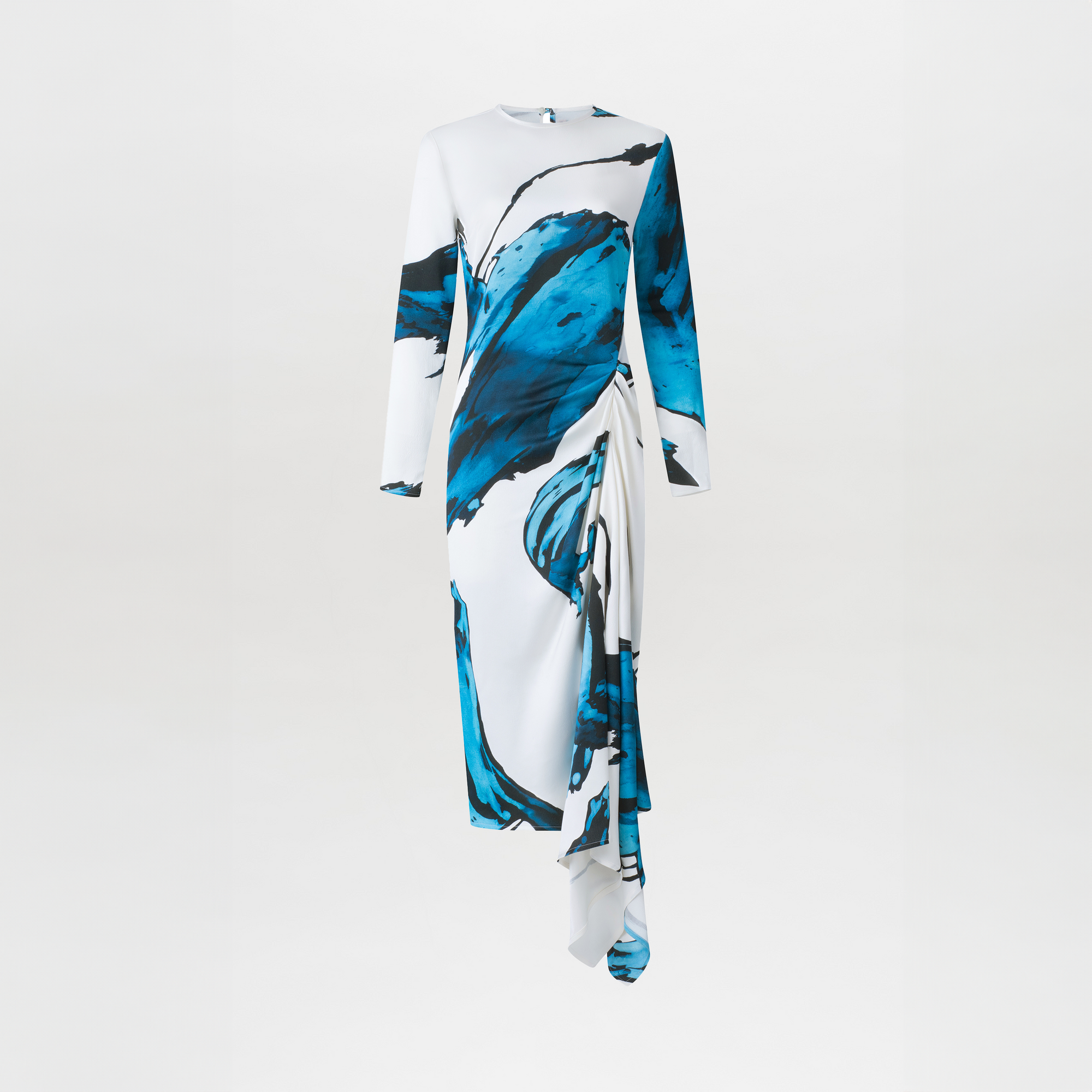 The Ananya Dress by SVT DESIGNS is a white, long-sleeved midi dress in soft jersey with blue and black abstract brushstroke patterns, an asymmetrical draped detail, and a plain white background.