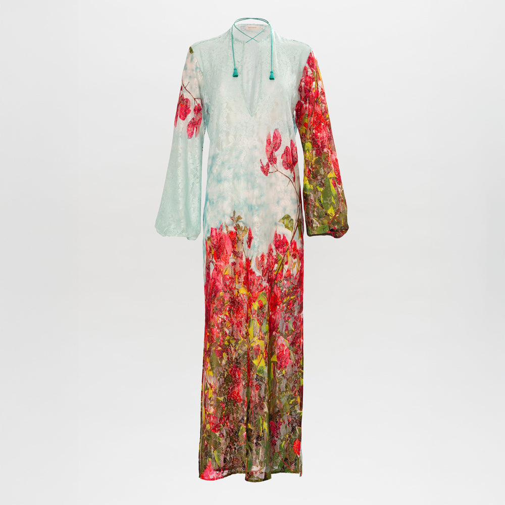 The SVT DESIGNS Mayfair Tunic is a long-sleeved, floor-length dress with a light blue top, vivid red and green floral print on the lower half and one sleeve, and a V-neckline with string tie.