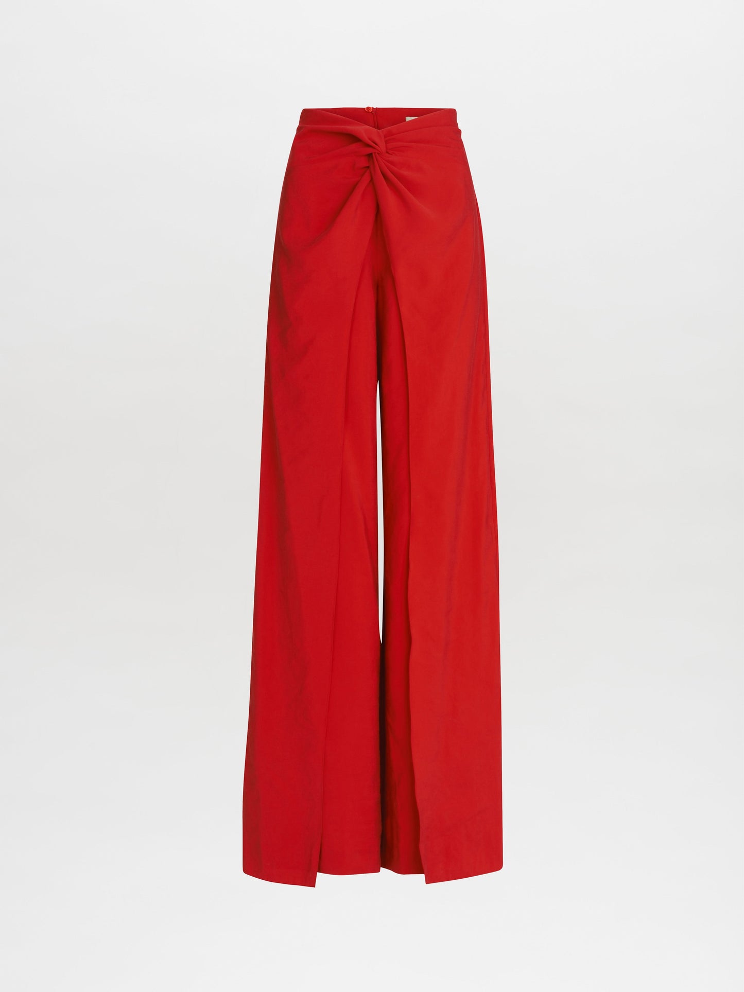 The Canturipe Pant by SVT DESIGNS features a wide-leg silhouette and a high-waist design with a front twisted knot detail, crafted from luxurious Italian fabric that flows gracefully to a floor-length hem against a plain white background.