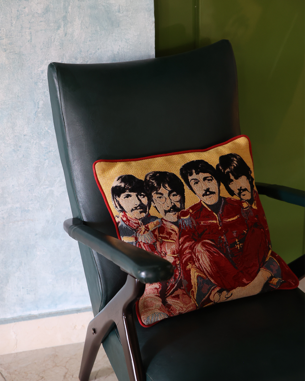 Pillow with a graphic of four individuals sitting on a black chair.