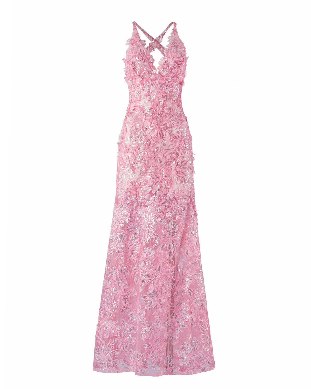 A person stands wearing the Daira Dress Pink, a long dress with thin straps and a beautiful floral pattern. The background is plain and light-colored. This elegant dress is now available for pre-order and will ship by February 1st, 2025.