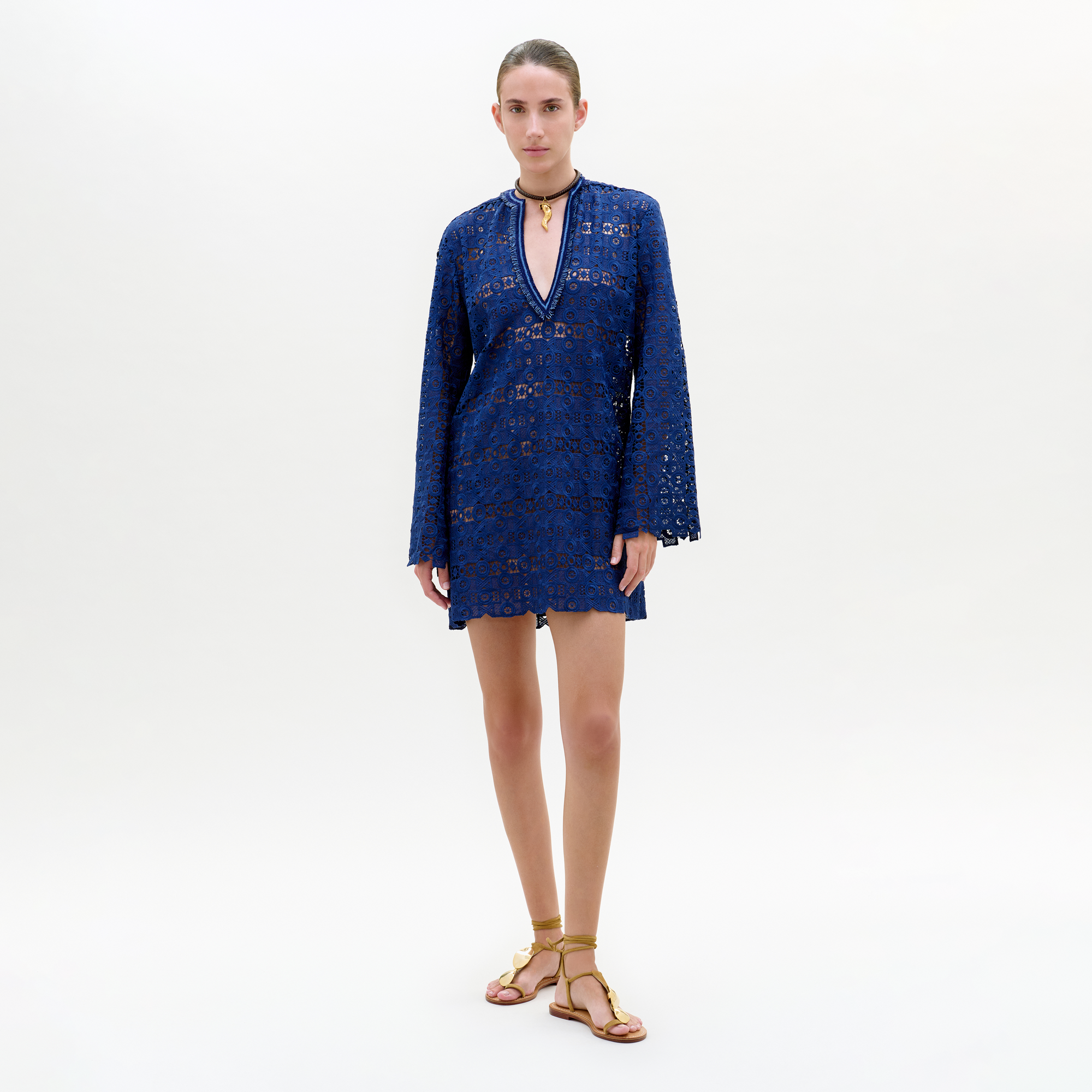 Woman wearing a blue lace dress on a white background