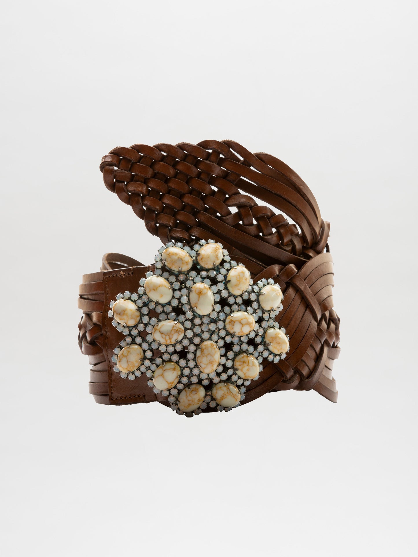 The Eines Belt by SVT DESIGNS is a wide brown braided leather accessory featuring a decorative centerpiece of clustered white and beige seashells against a plain white background.