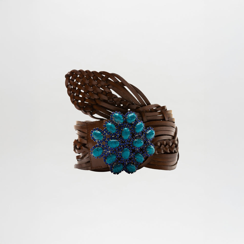 The Eines Belt by SVT DESIGNS, a braided brown Italian leather belt with a large, ornate blue gemstone buckle, is shown against a plain white background.