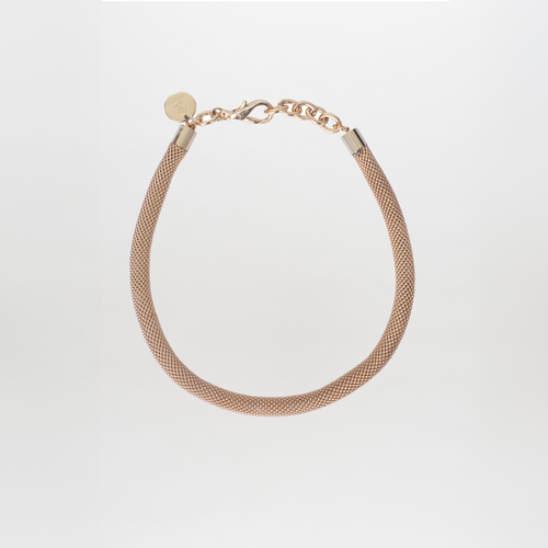 The Elara Necklace by SVT DESIGNS is a gold-plated brass chain piece with a textured design, featuring a chain clasp and round tag engraved with Tcherassi motifs, showcased elegantly on a plain white background.