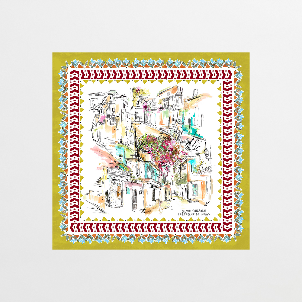 A vibrant, hand-drawn design of a Mediterranean village with flowers and white buildings, framed by an ornate border reflecting the red, blue, and gold patterns of the Callecitas De Cartagena Scarf.