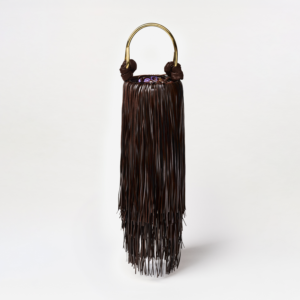 Black fringe bag with gold handle on a white background