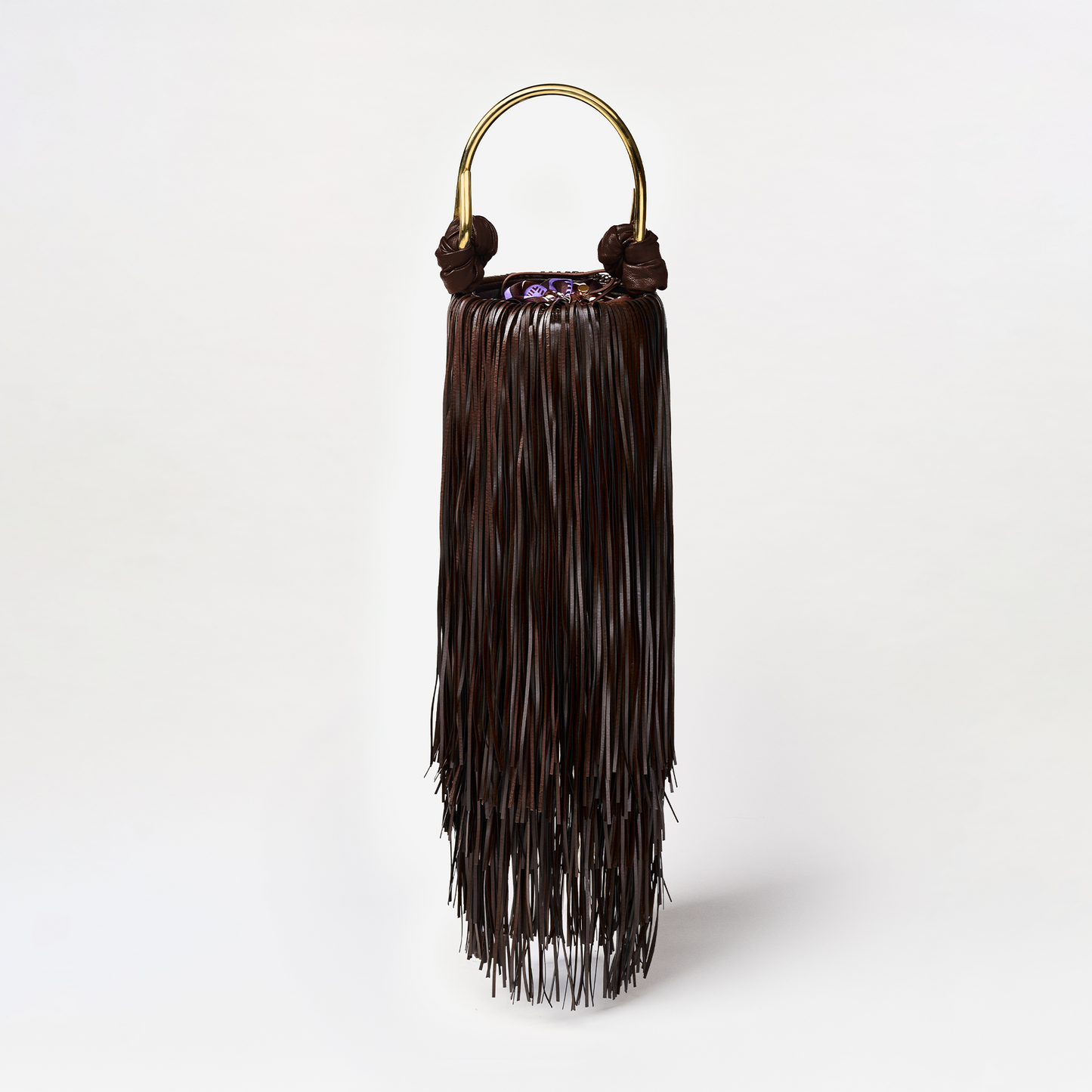 Black fringe bag with gold handle on a white background
