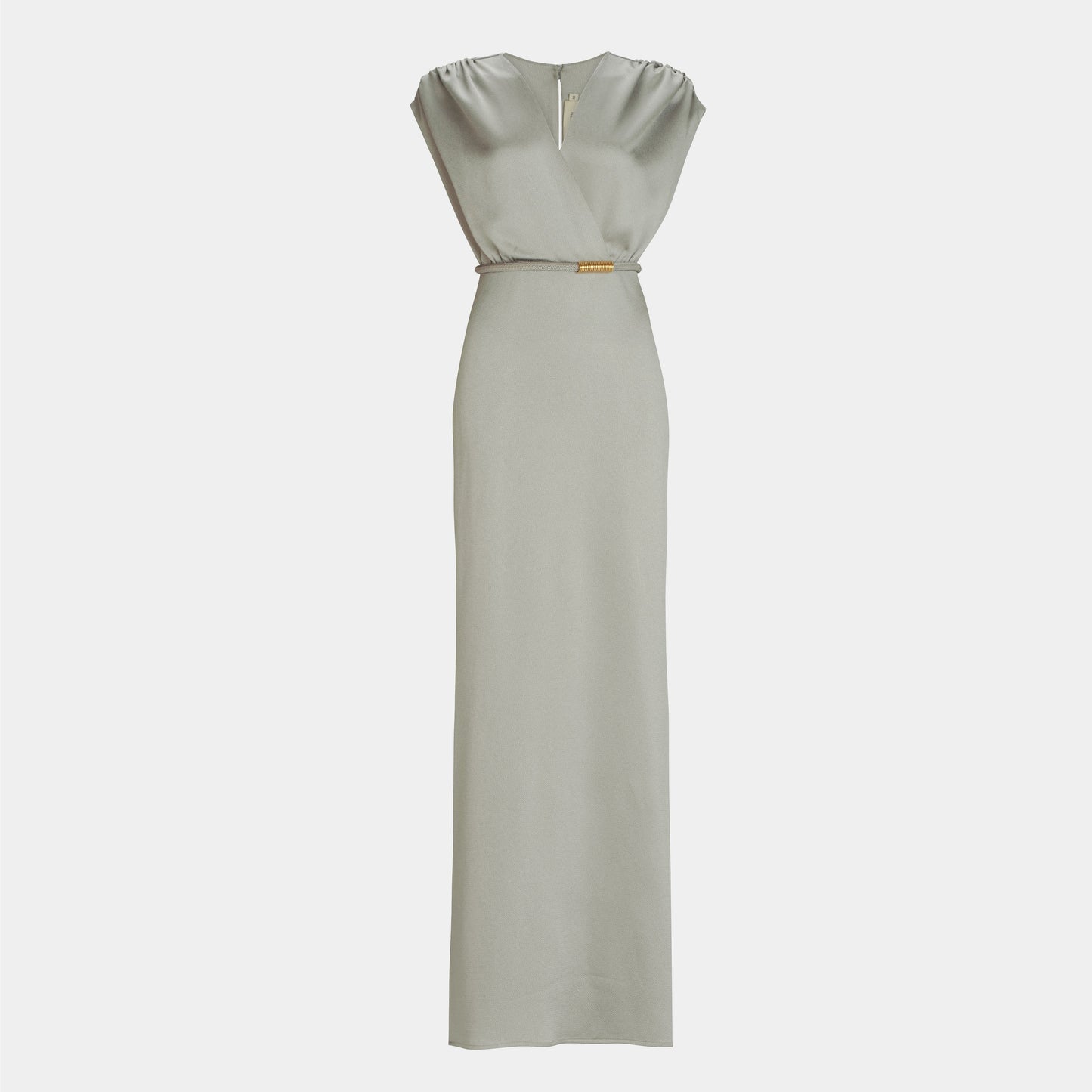 The Freda Dress by SVT DESIGNS is a light gray, floor-length maxi with a V-neckline, sleeveless design, subtle shoulder gathers, a fitted silhouette, and a small metallic accent at the waist.